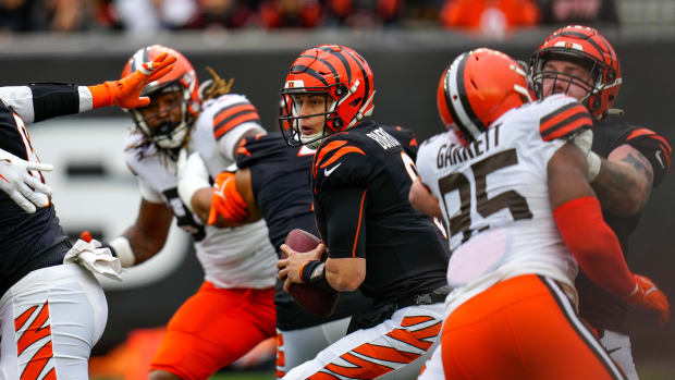 Cincinnati Bengals quarterback Joe Burrow (9) protects the ball in the pocket under pressure from Cleveland Browns defensive end Myles Garrett (95) in the second quarter of the NFL Week 14 game between the Cincinnati Bengals and the Cleveland Browns at Paycor Stadium in Cincinnati on Sunday, Dec. 11, 2022. The Bengals led 13-3 at halftime. Cleveland Browns At Cincinnati Bengals Week 14